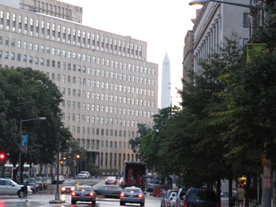 The Washington Monument peeking out from behind the Export-Import Bank and Dana buildings, L Street NW, looking south on 15th Street, Washington, D.C., 21 August 2009